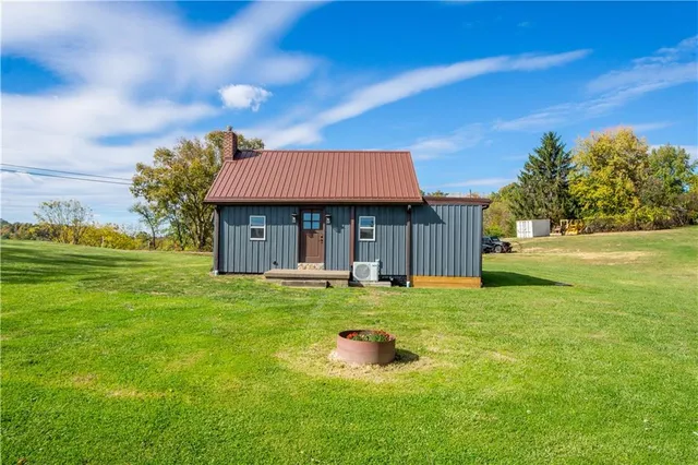 a front view of a house with yard and green space