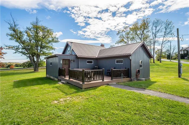 a view of a house with a yard porch and sitting area
