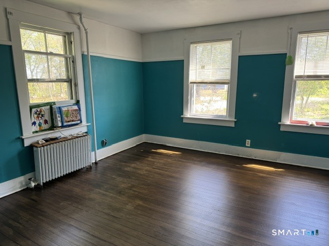 408 Huntington Road Scotland, CT 06264 - Photo 4 of 10 an empty room with wooden floor and windows
