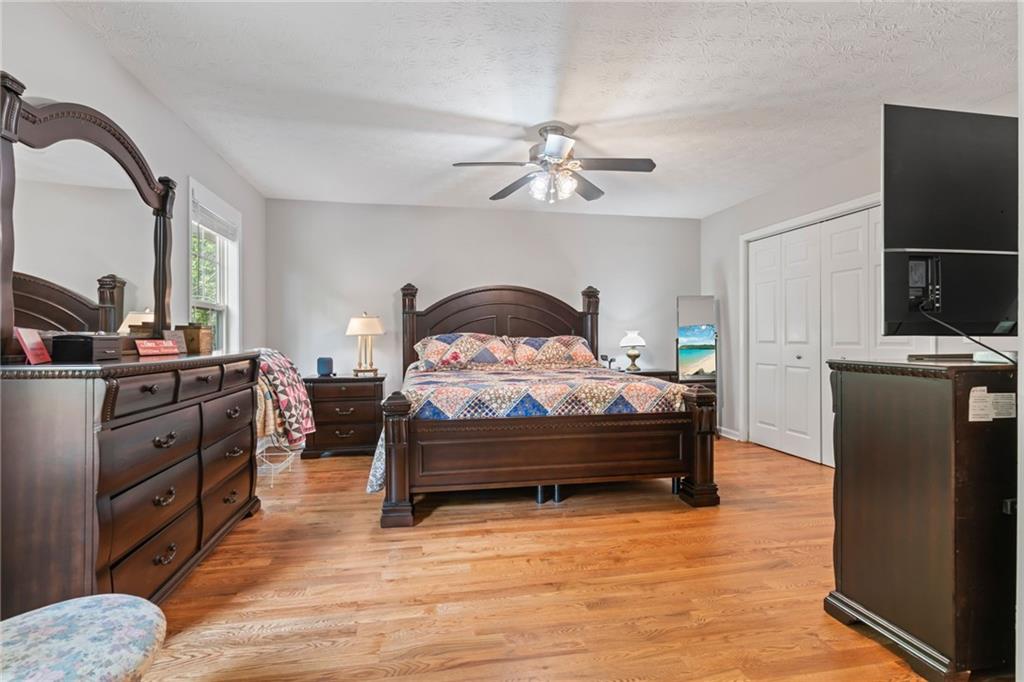 86 Back Trail Cleveland, GA 30528 - Photo 19 of 53 a bedroom with a bed and a chandelier