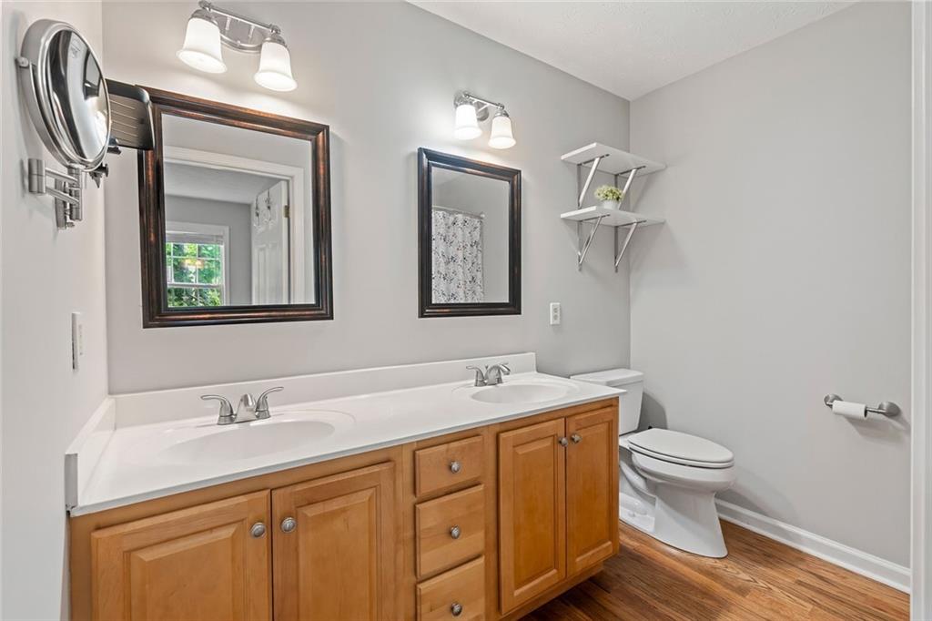 86 Back Trail Cleveland, GA 30528 - Photo 21 of 53 a bathroom with a toilet a sink a mirror and a window