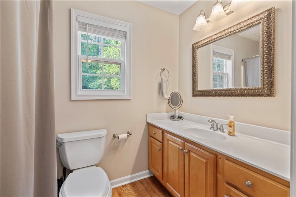 86 Back Trail Cleveland, GA 30528 - Photo 23 of 53 a bathroom with a toilet sink and mirror
