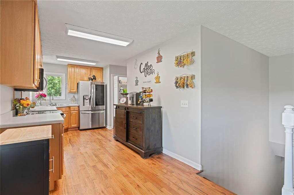 86 Back Trail Cleveland, GA 30528 - Photo 25 of 53 a kitchen with a refrigerator a stove top oven a counter space and a window
