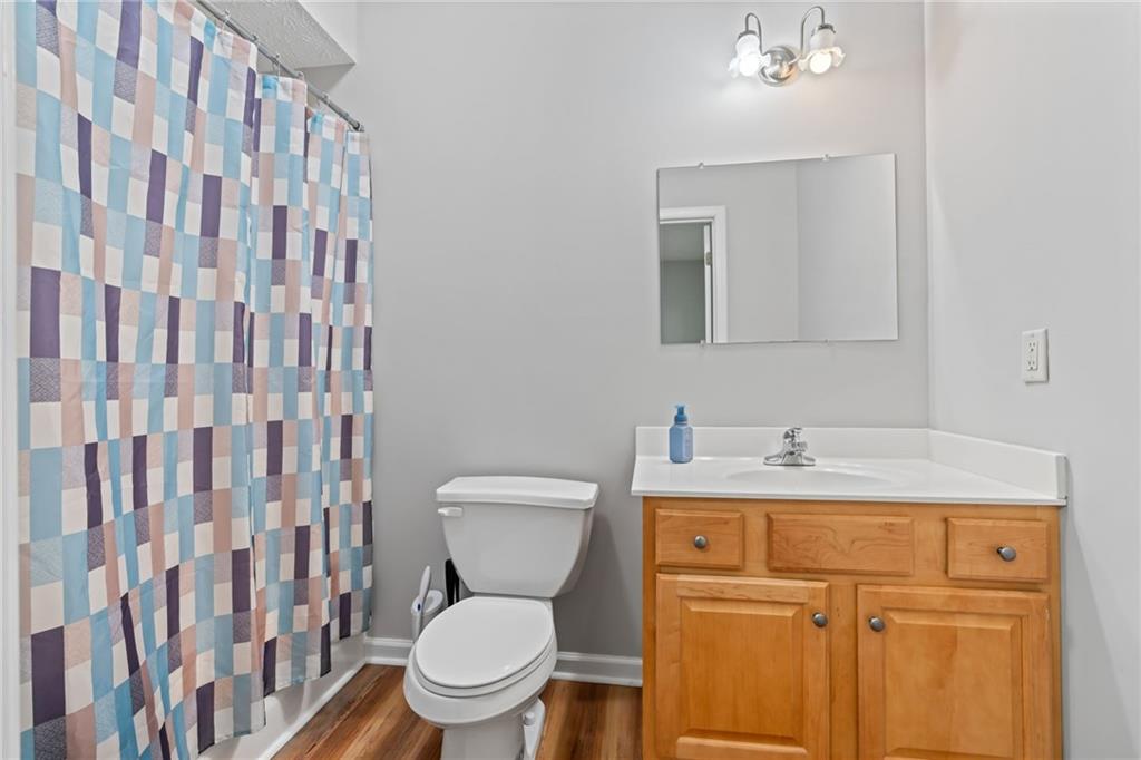 86 Back Trail Cleveland, GA 30528 - Photo 30 of 53 a bathroom with a granite countertop sink toilet and mirror