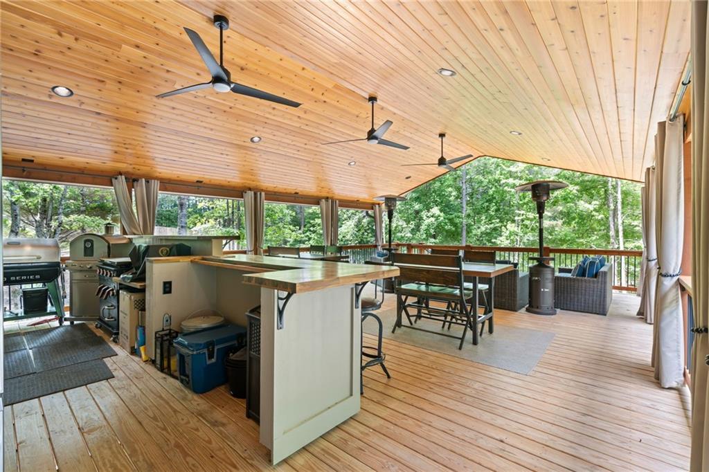 86 Back Trail Cleveland, GA 30528 - Photo 34 of 53 a view of a patio with a dining table chairs and wooden floor
