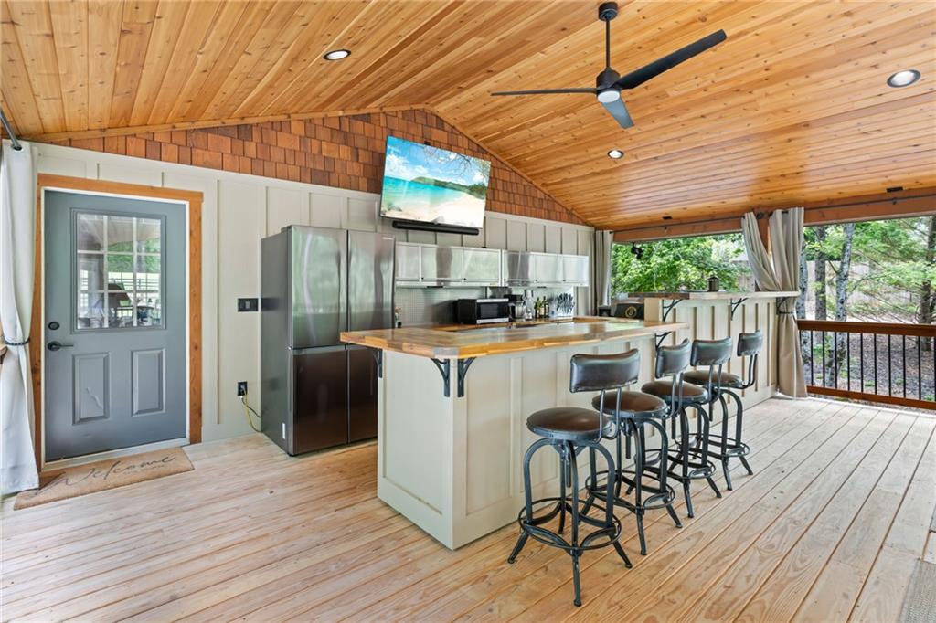 86 Back Trail Cleveland, GA 30528 - Photo 5 of 53 a kitchen with stainless steel appliances granite countertop a refrigerator a sink dishwasher a stove and white countertops with wooden floor