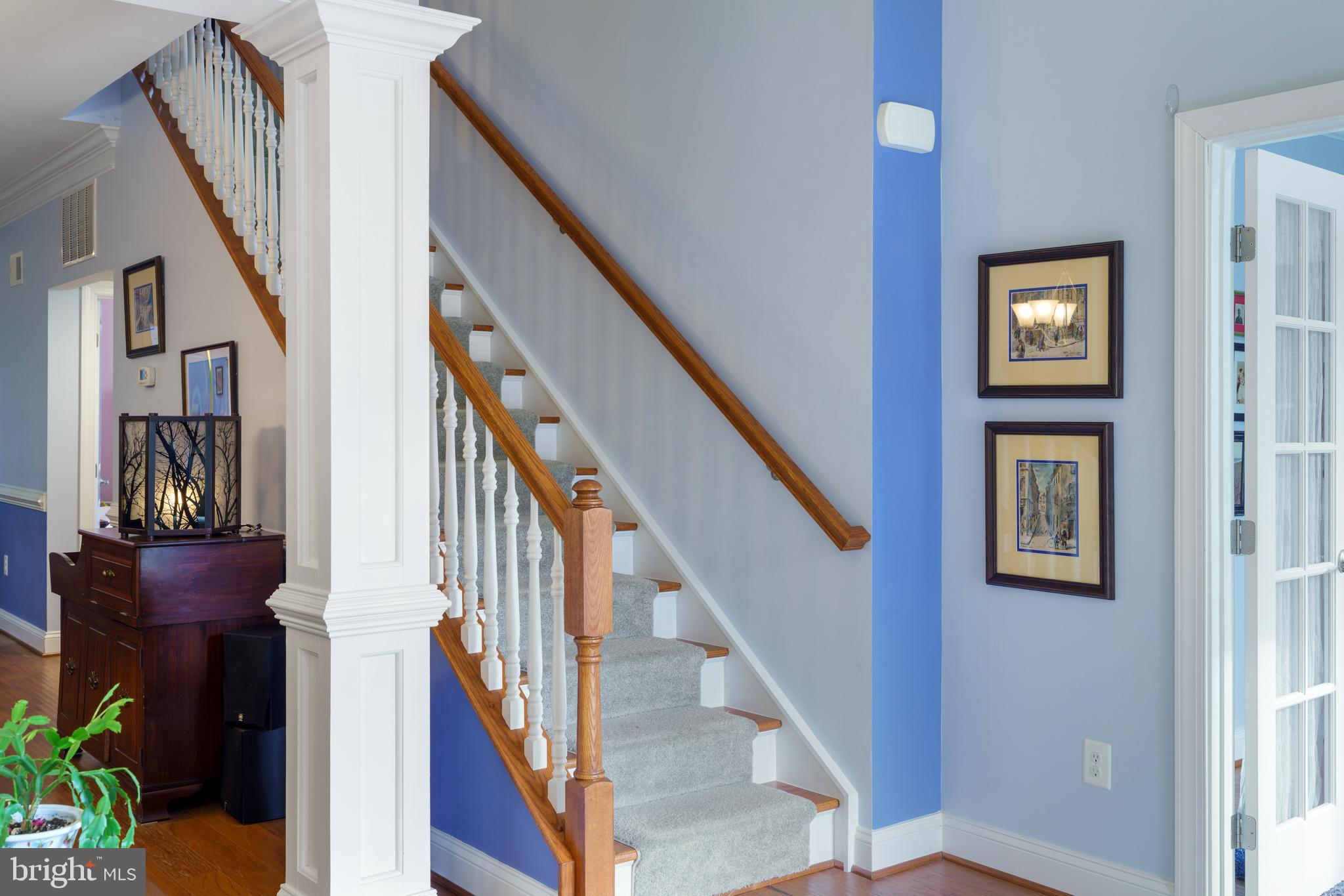 6926 Summit Circle Baltimore, MD 21239 - Photo 8 of 52 a view of staircase with lots of frames on wall and windows
