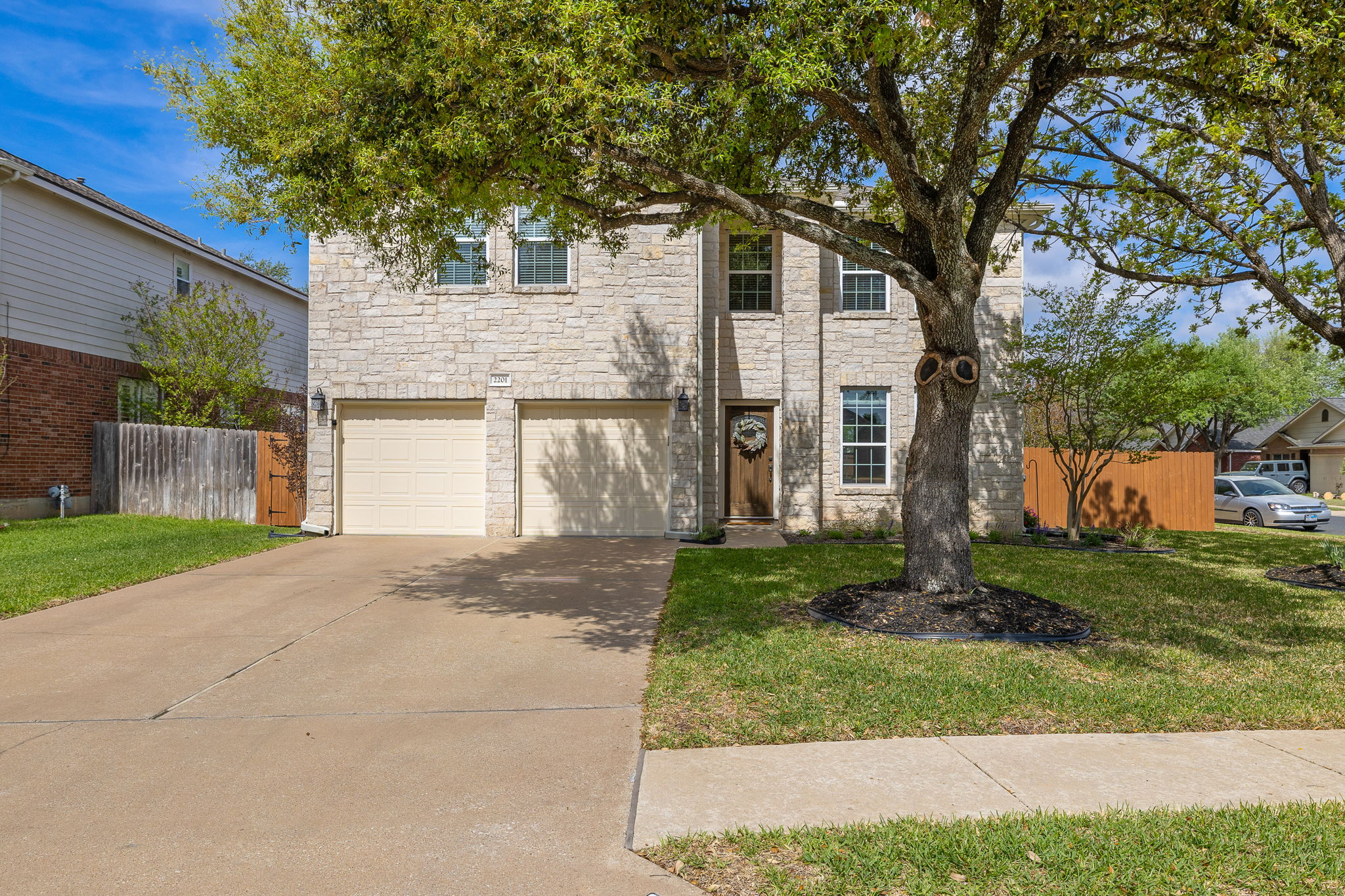 Come home to gorgeous curb appeal with shade trees and Austin-style limestone