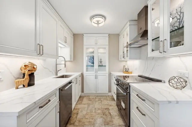 a kitchen with a sink stove and cabinets