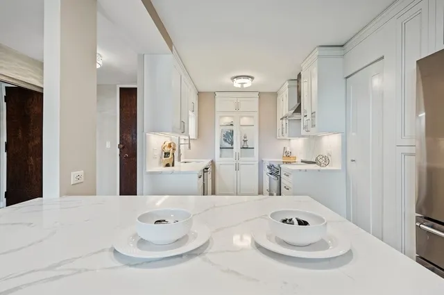 a bathroom with a sink a white tub and shower