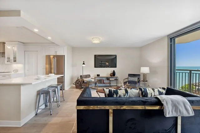 a living room with furniture and a lamp