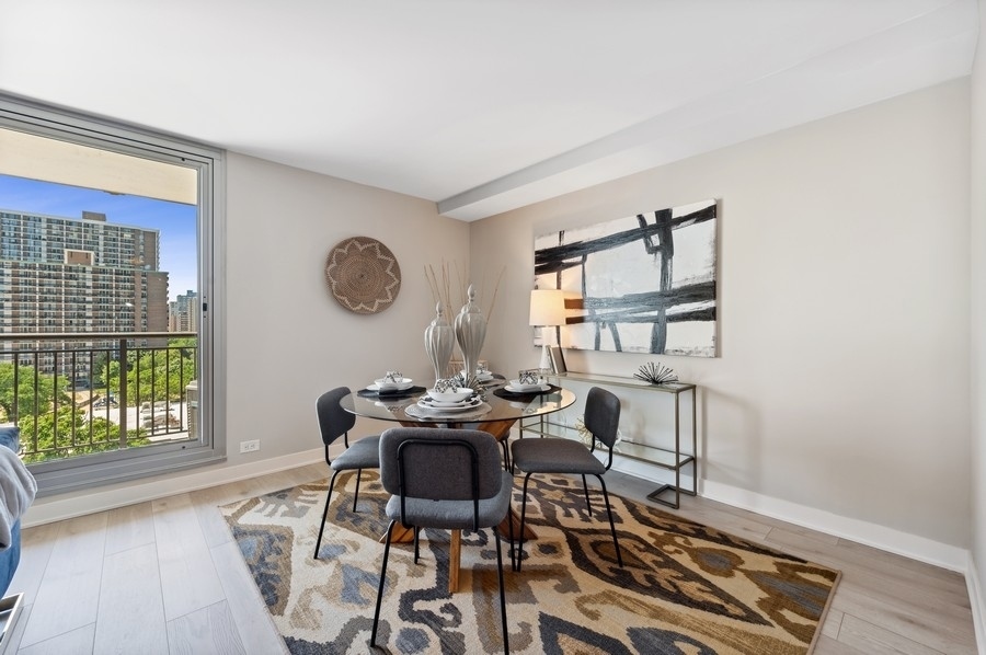 6007 North Sheridan Road, Unit 7J Chicago, IL 60660 - Photo 8 of 25 a view of a dining room with furniture and wooden floor
