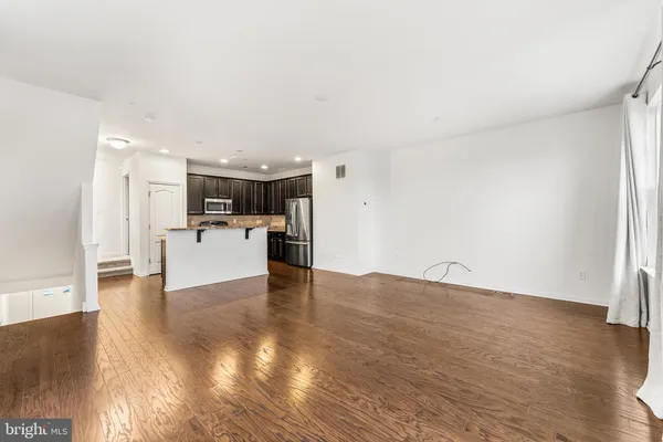 a view of a kitchen with a sink and a refrigerator