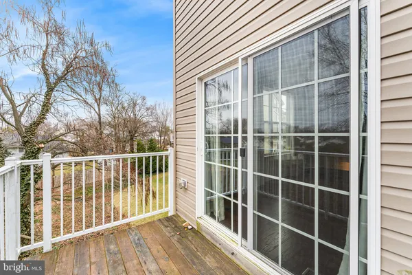a view of a balcony with a floor to ceiling window with wooden fence