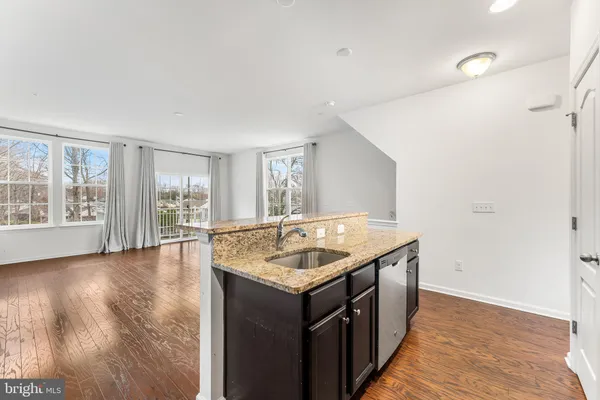 a bathroom with a granite countertop sink and a large mirror