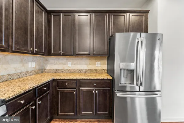 a kitchen with a refrigerator and cabinets