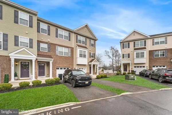 a front view of a residential apartment building with a yard