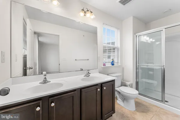 a bathroom with a glass shower door