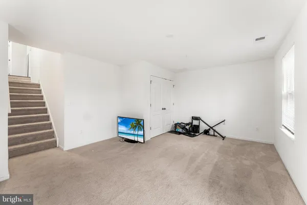 a view of a room with stairs and a window