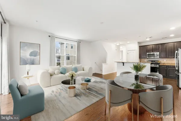 a living room with furniture and kitchen view