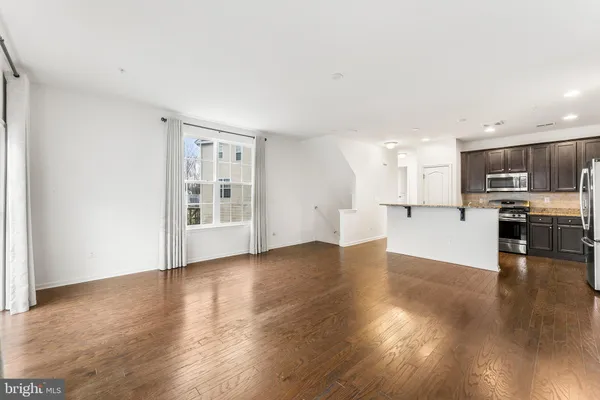 a view of kitchen with wooden floor and a window