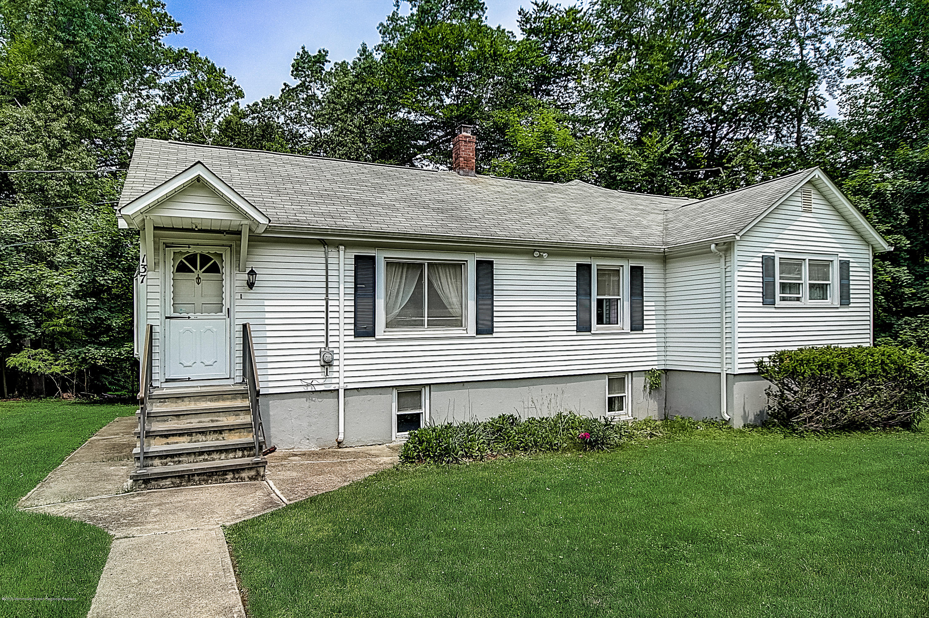 137 Pond Road Freehold, NJ 07728 - Photo 1 of 52 a front view of a house with a yard