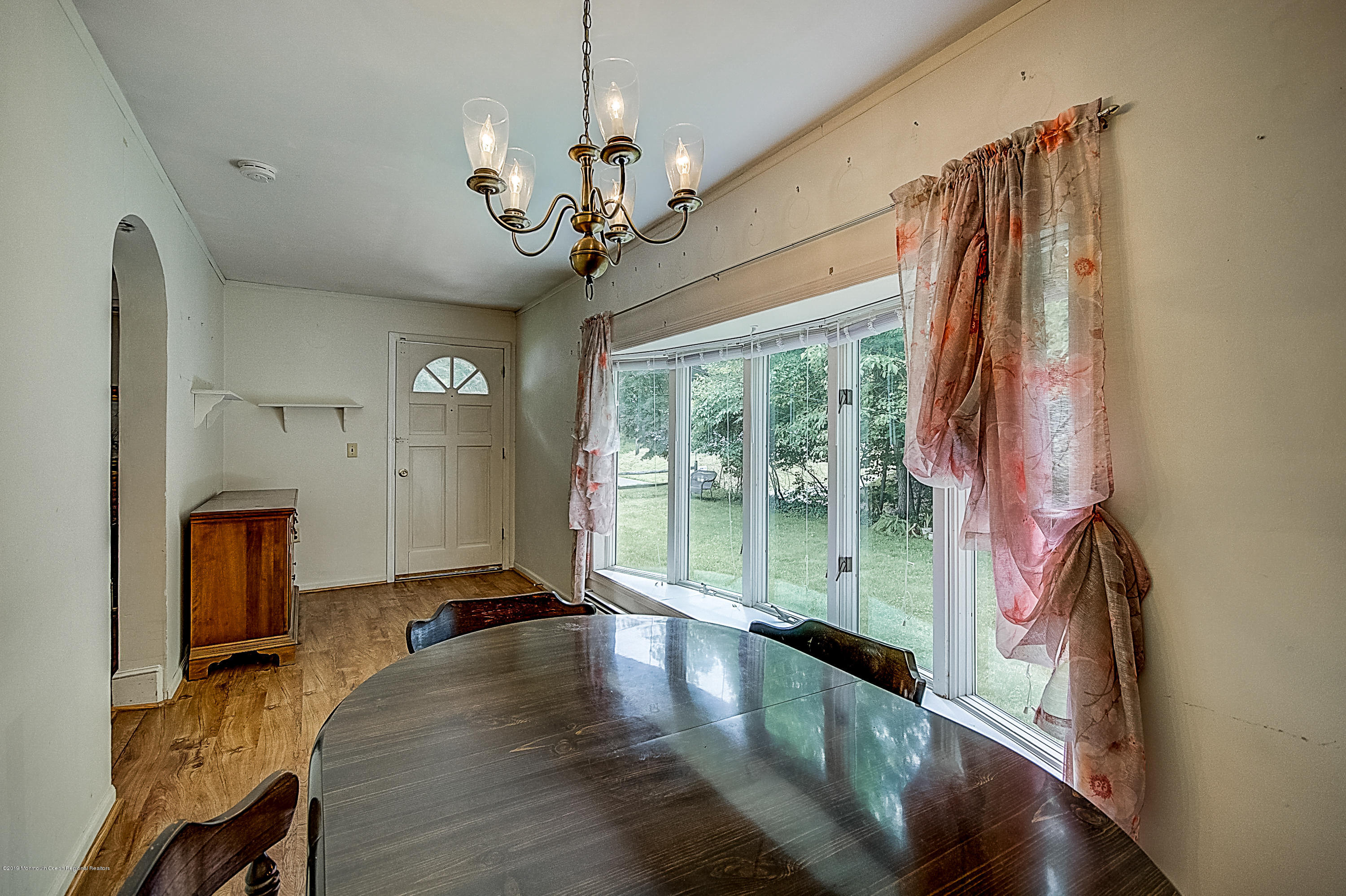137 Pond Road Freehold, NJ 07728 - Photo 11 of 52 a view of a dining room with furniture wooden floor and chandelier