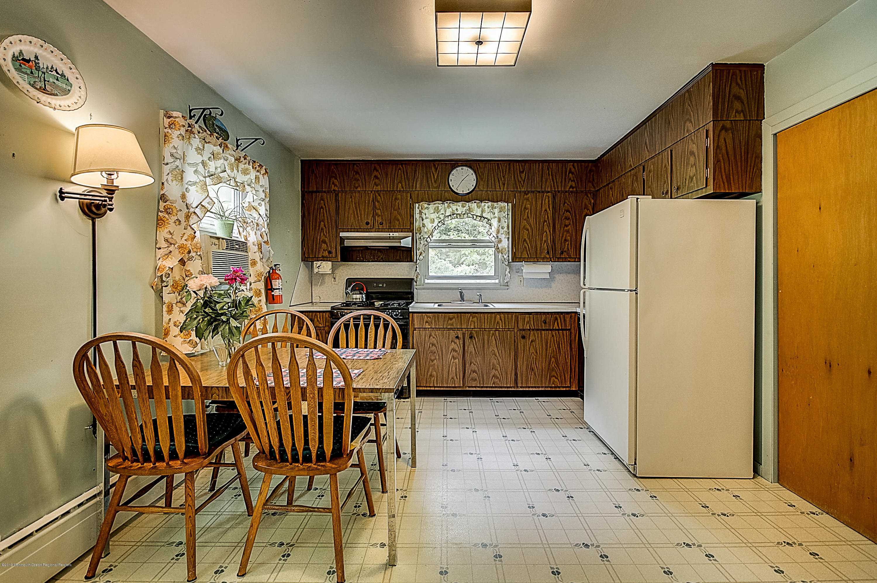 137 Pond Road Freehold, NJ 07728 - Photo 13 of 52 a kitchen with a refrigerator a table and chairs