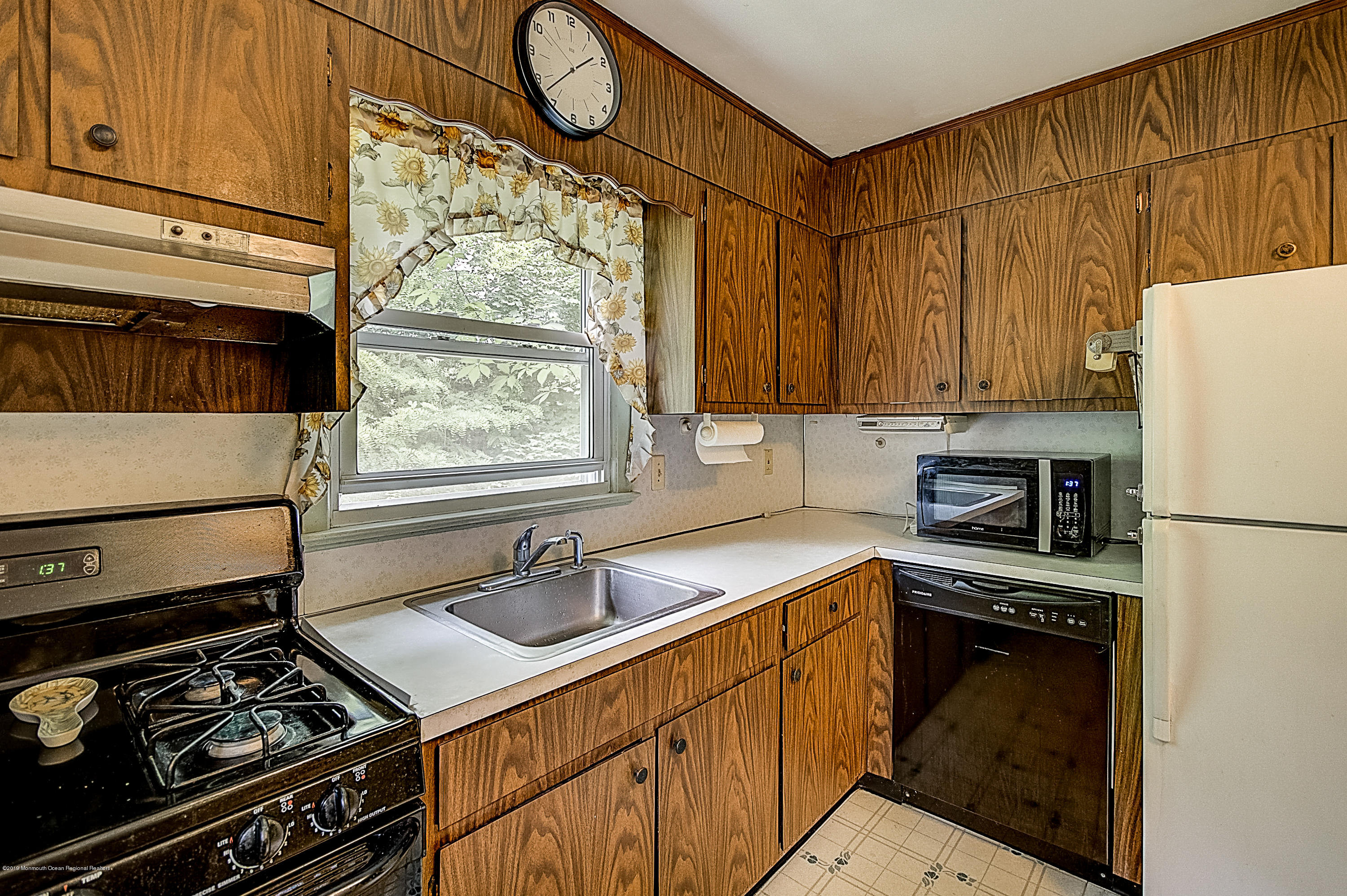 137 Pond Road Freehold, NJ 07728 - Photo 16 of 52 a kitchen with a stove a sink and a refrigerator