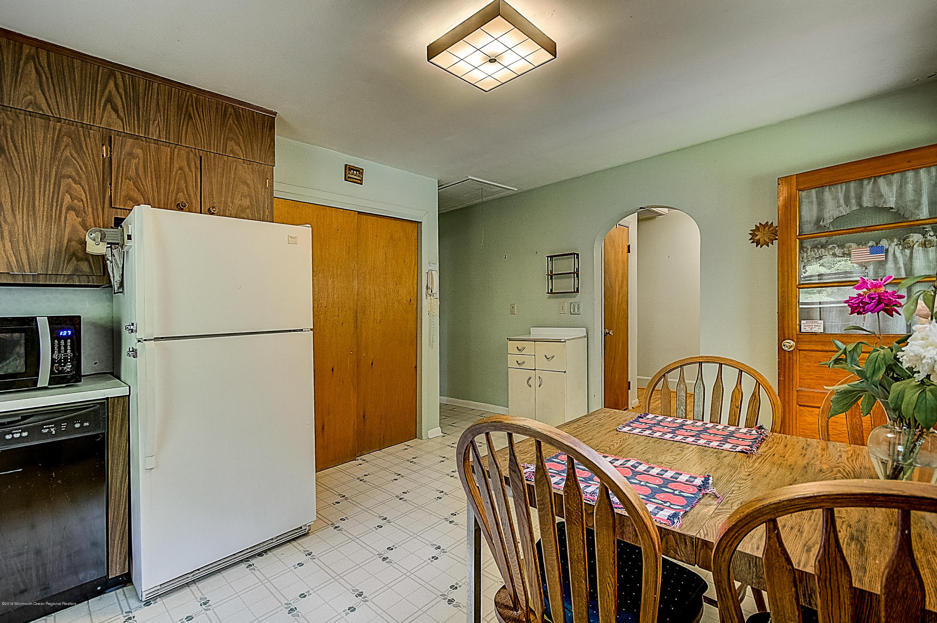 137 Pond Road Freehold, NJ 07728 - Photo 17 of 52 a kitchen with stainless steel appliances granite countertop a refrigerator a stove a sink dishwasher and white cabinets with wooden floor