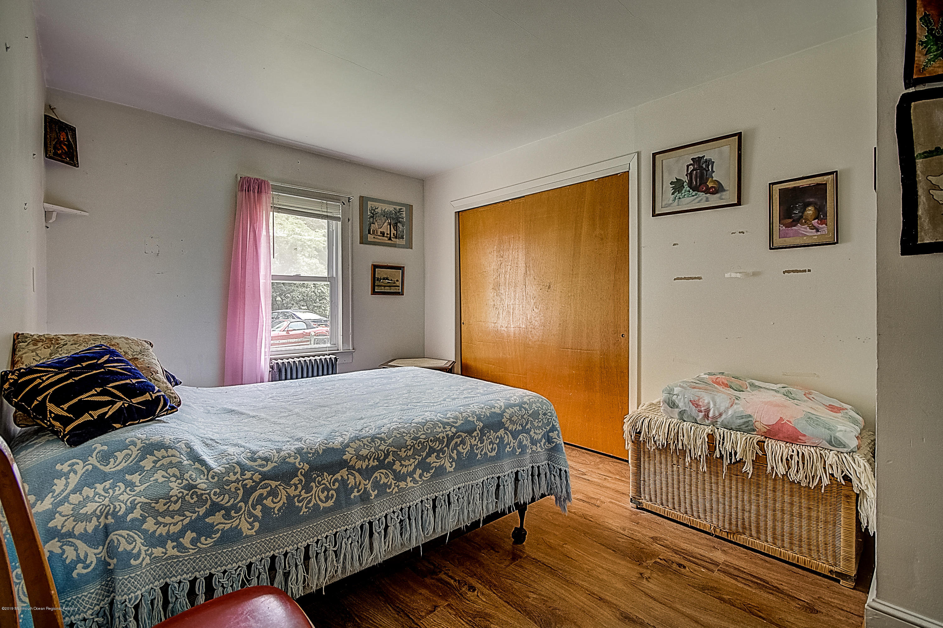 137 Pond Road Freehold, NJ 07728 - Photo 19 of 52 a bedroom with a bed and wooden floor