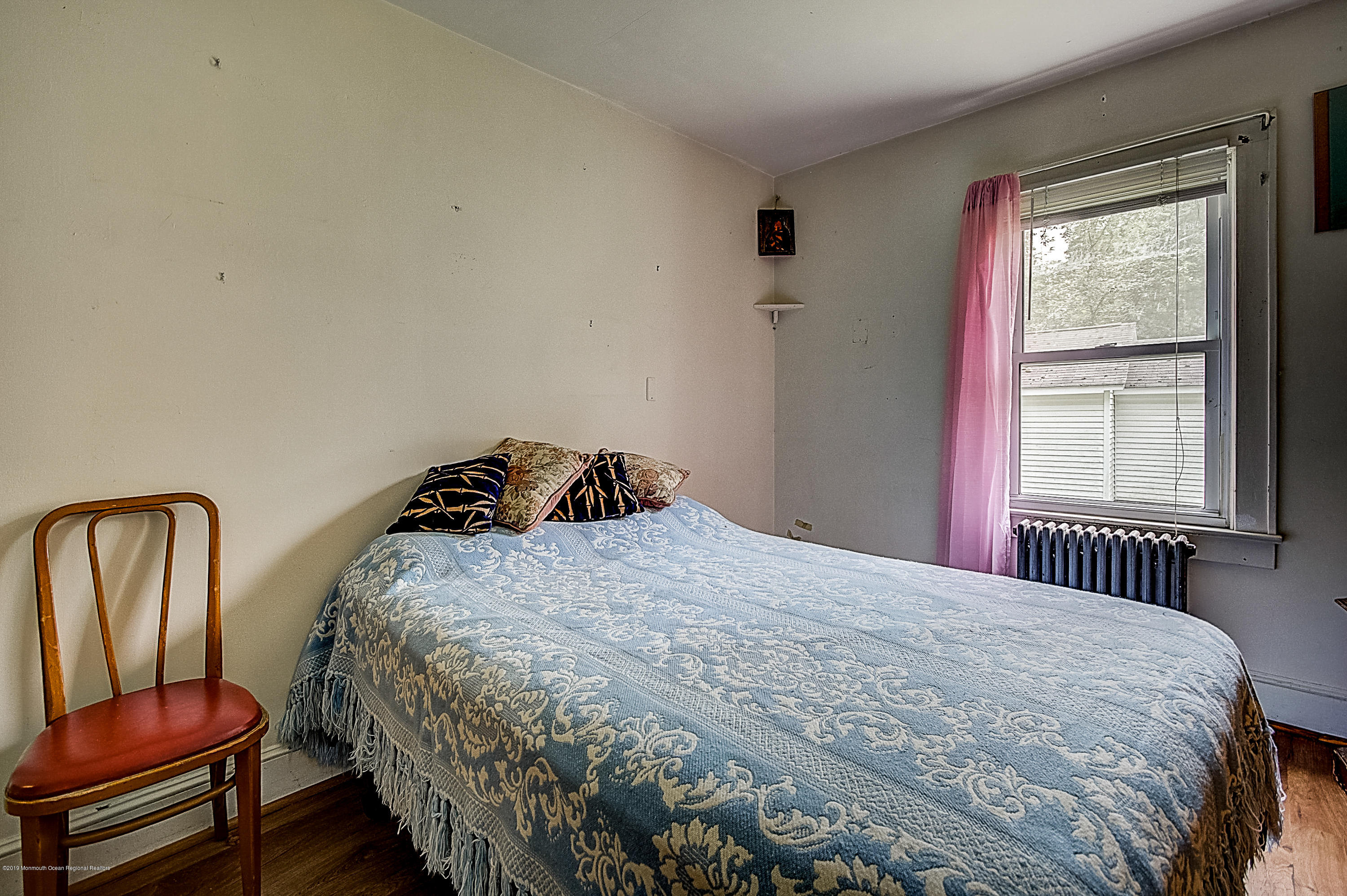137 Pond Road Freehold, NJ 07728 - Photo 20 of 52 a bedroom with a bed and chair