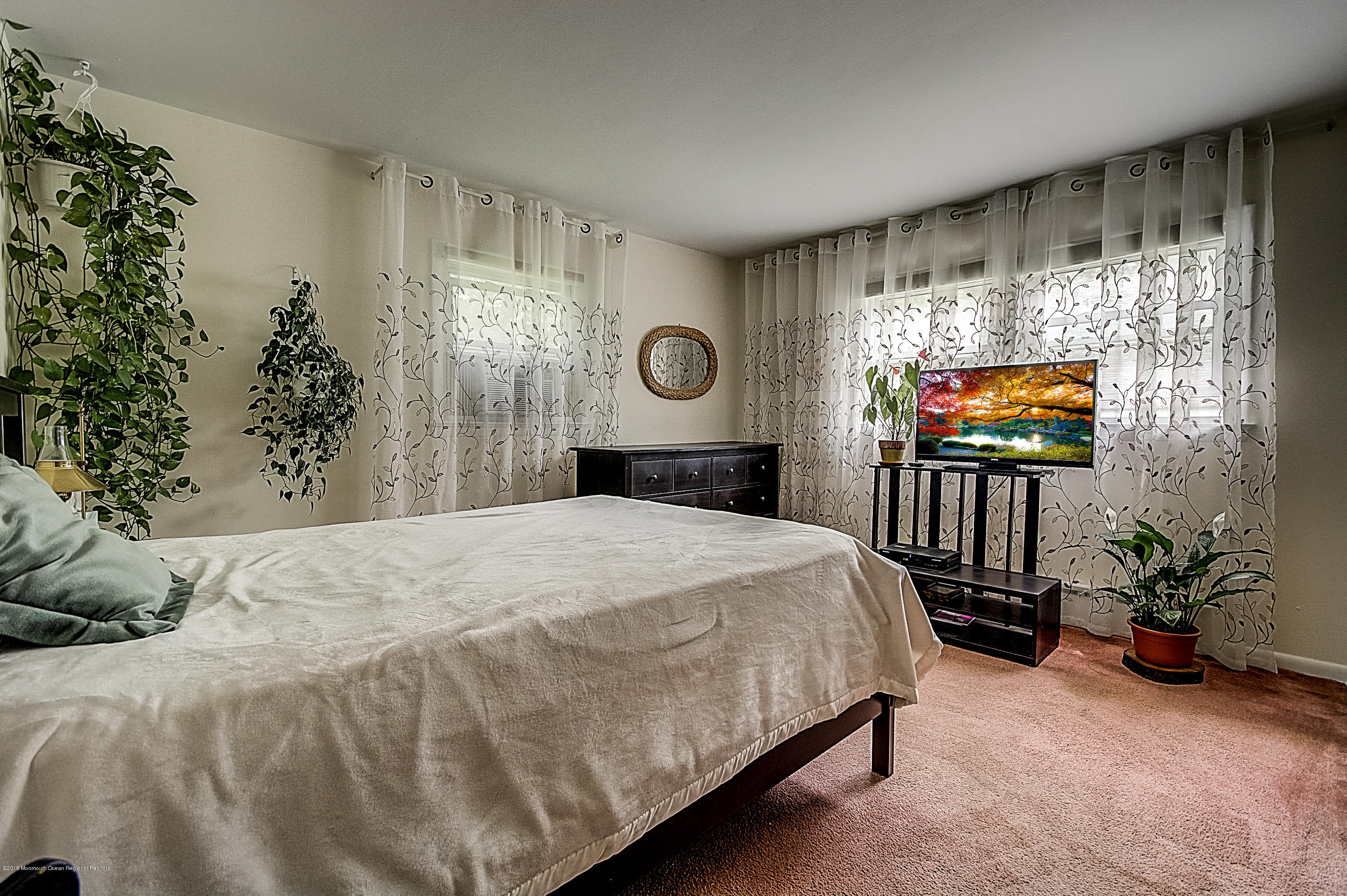 137 Pond Road Freehold, NJ 07728 - Photo 26 of 52 a bedroom with a bed and a flat screen tv
