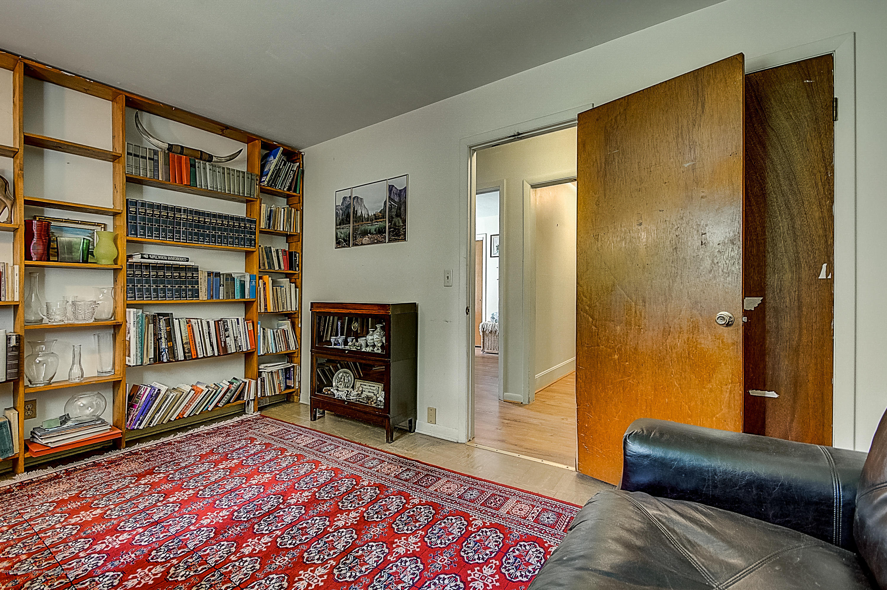 137 Pond Road Freehold, NJ 07728 - Photo 30 of 52 a living room with a couch and a book shelf