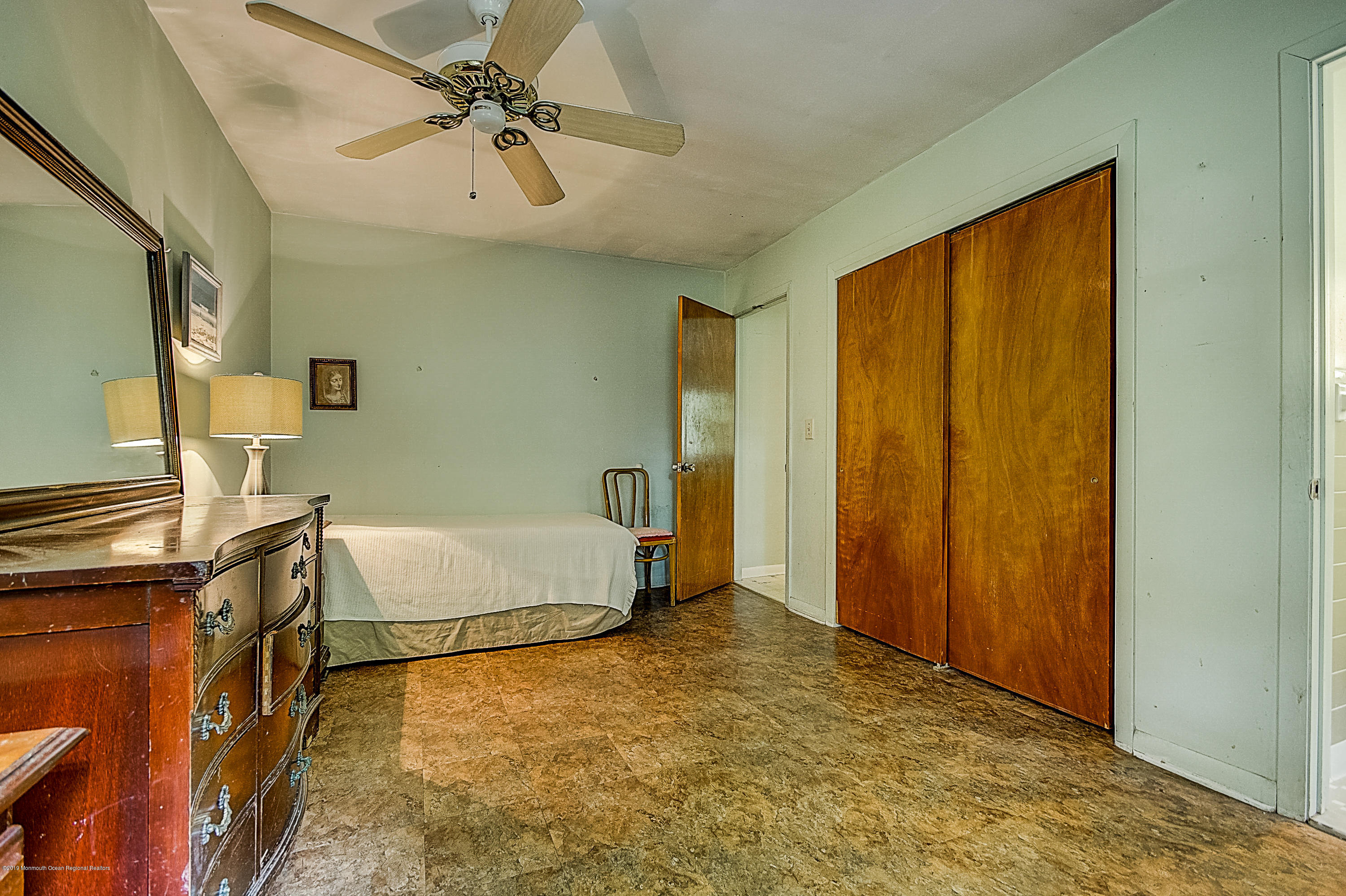 137 Pond Road Freehold, NJ 07728 - Photo 35 of 52 a living room with a bed furniture and a ceiling fan