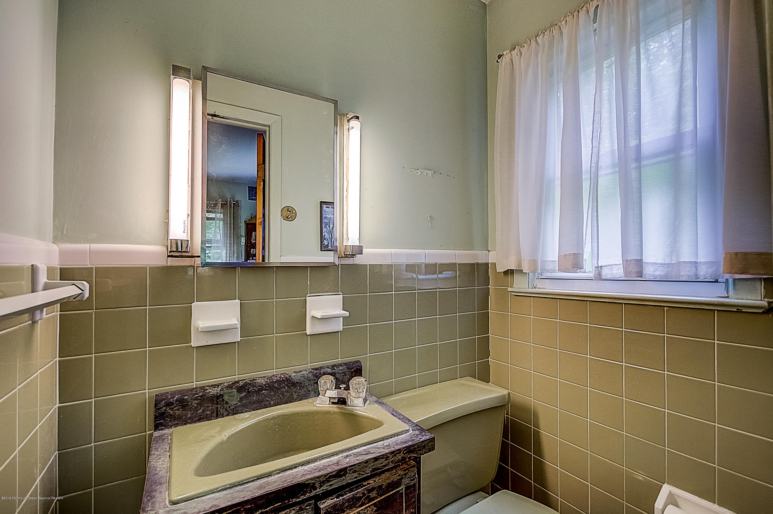 137 Pond Road Freehold, NJ 07728 - Photo 37 of 52 a bathroom with a sink toilet and mirror