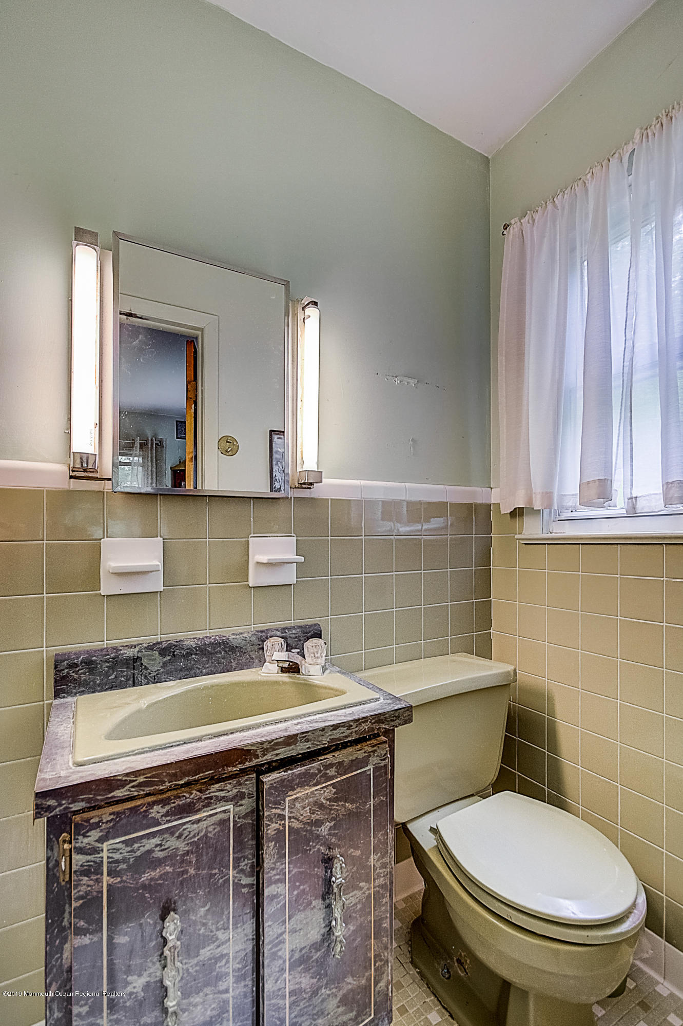 137 Pond Road Freehold, NJ 07728 - Photo 38 of 52 a bathroom with a toilet a sink and mirror