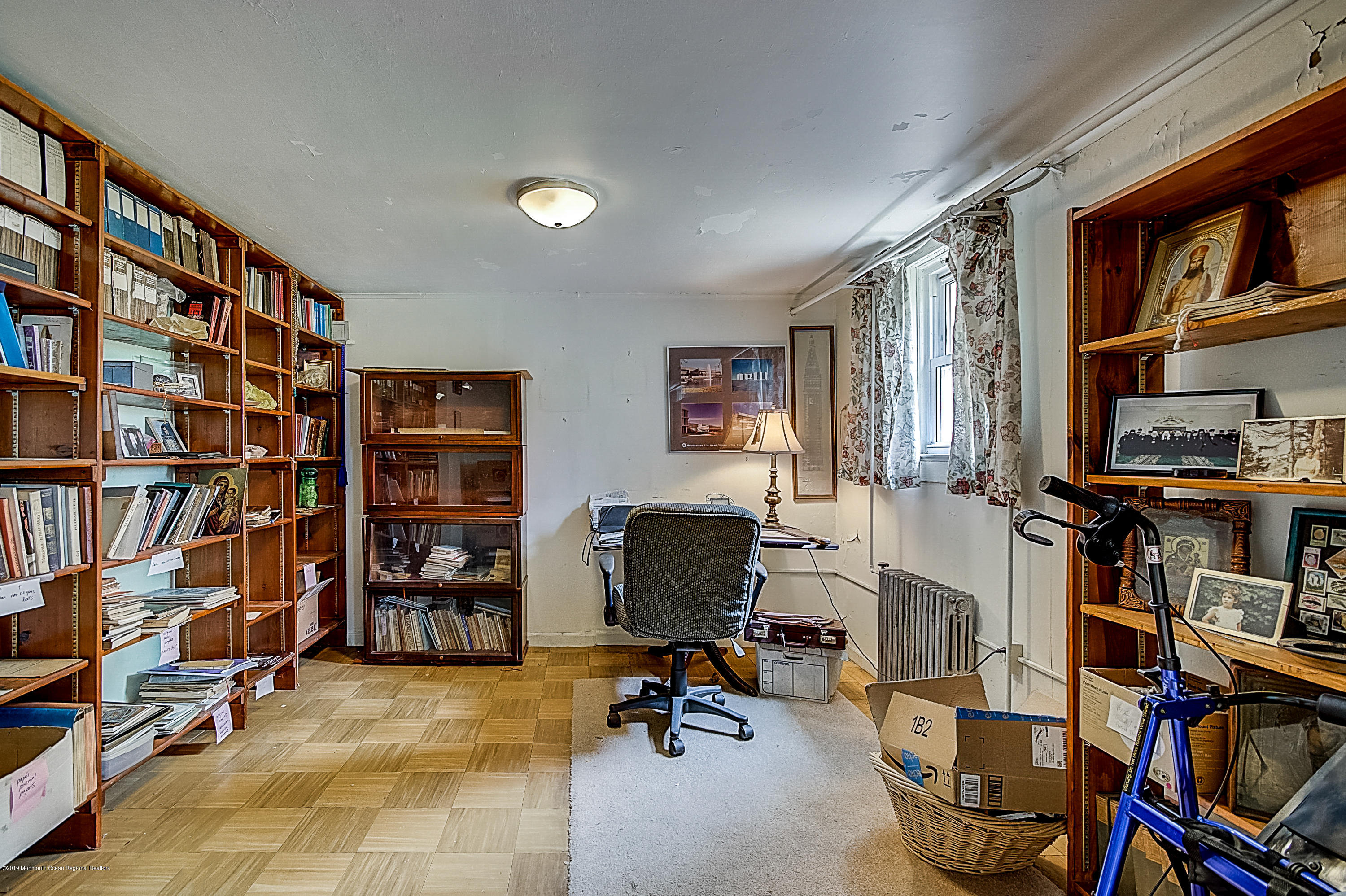137 Pond Road Freehold, NJ 07728 - Photo 42 of 52 a view of a livingroom with workspace and a bookshelf