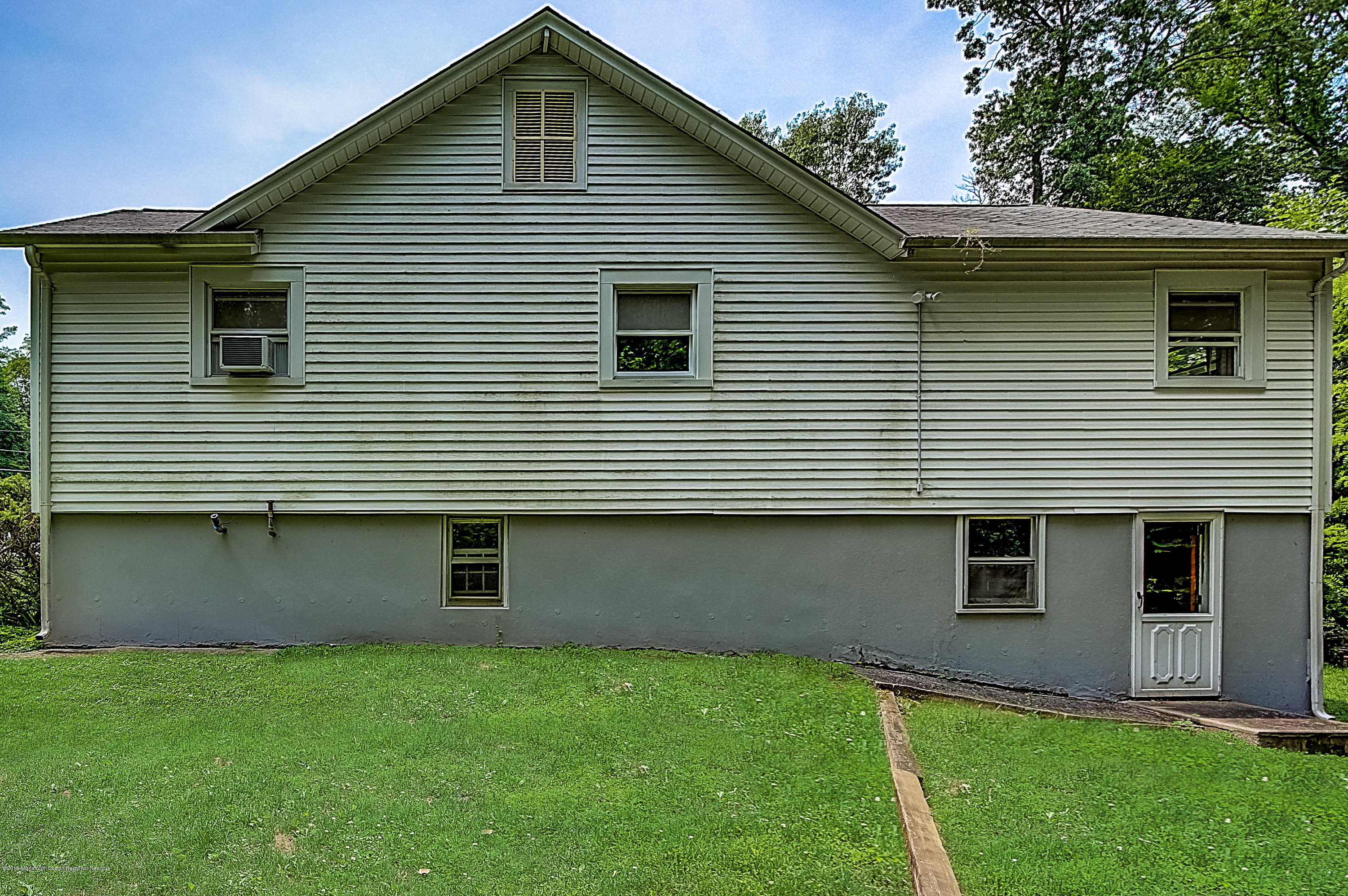 137 Pond Road Freehold, NJ 07728 - Photo 50 of 52 a front view of a house with a garden