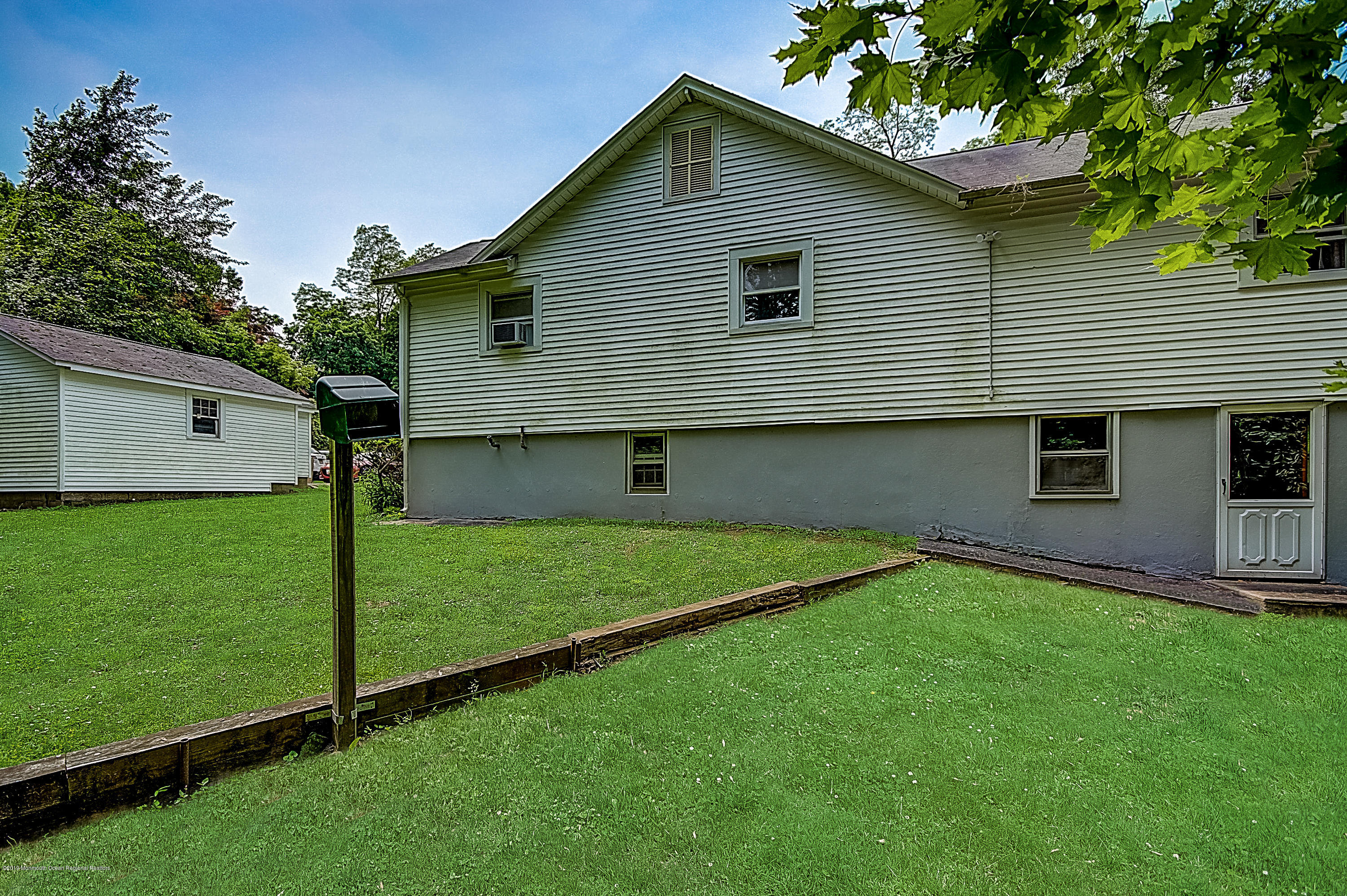 137 Pond Road Freehold, NJ 07728 - Photo 51 of 52 a front view of house with a garden