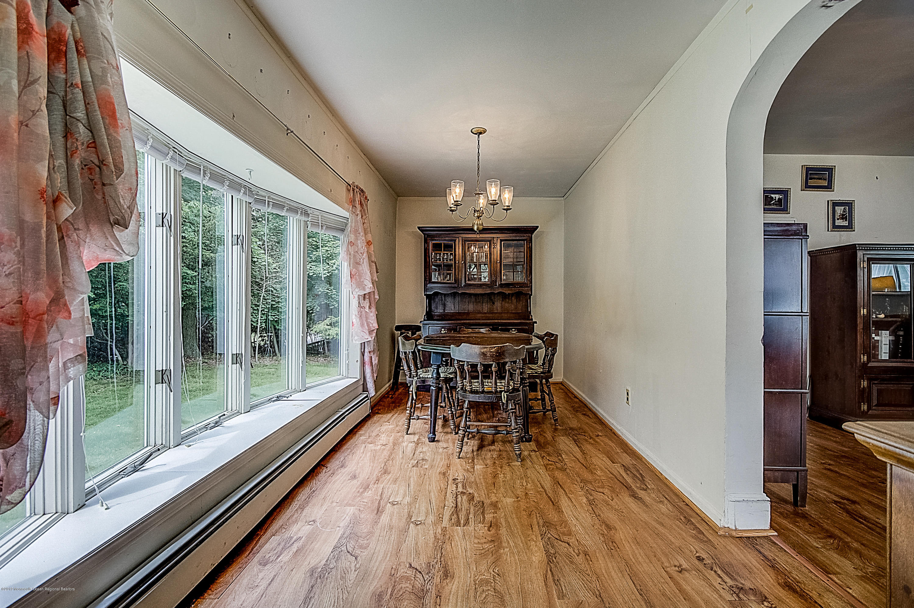 137 Pond Road Freehold, NJ 07728 - Photo 9 of 52 a view of a dining room with furniture window and wooden floor