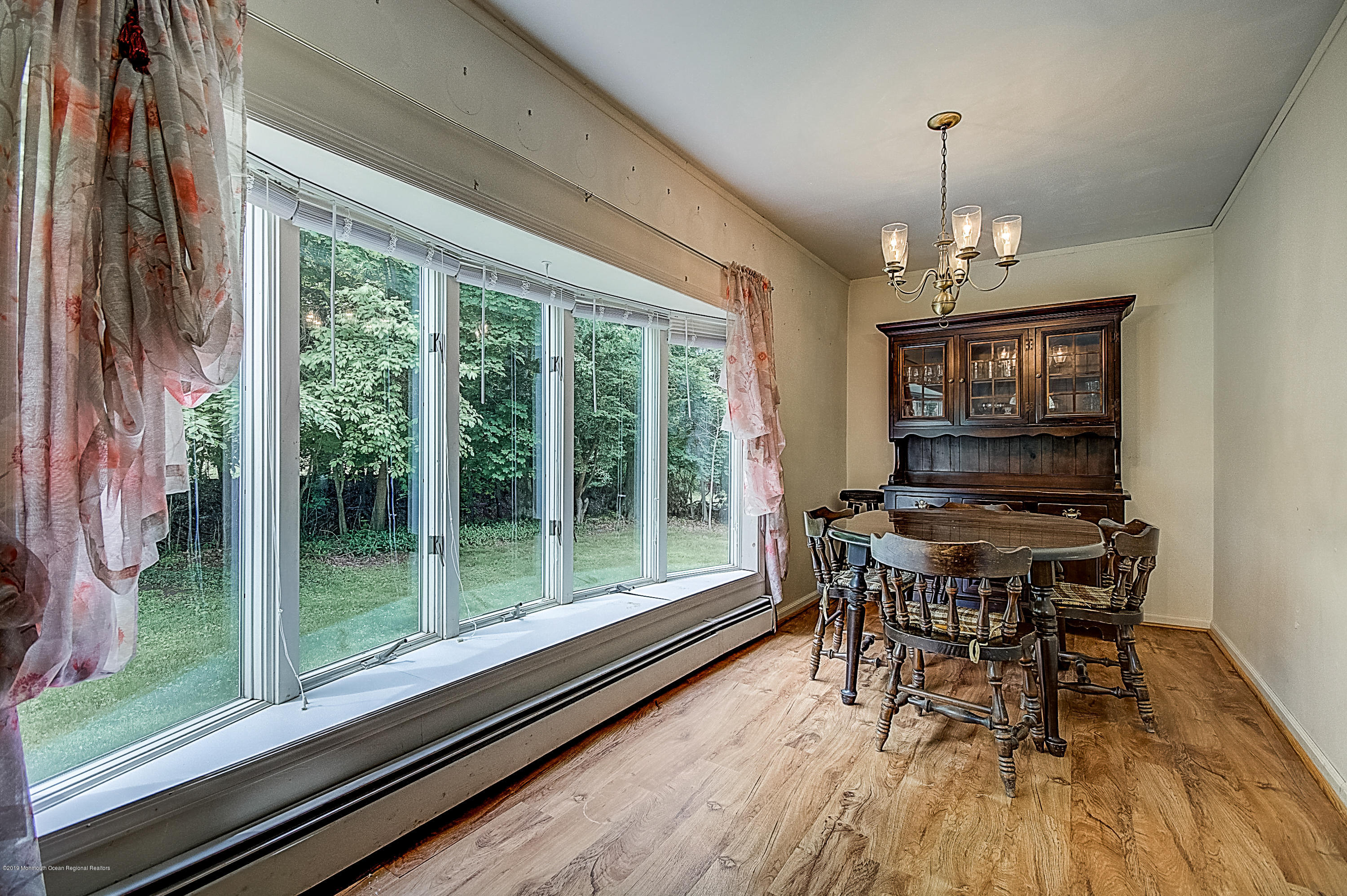 137 Pond Road Freehold, NJ 07728 - Photo 10 of 52 a view of a dining room with furniture window and wooden floor