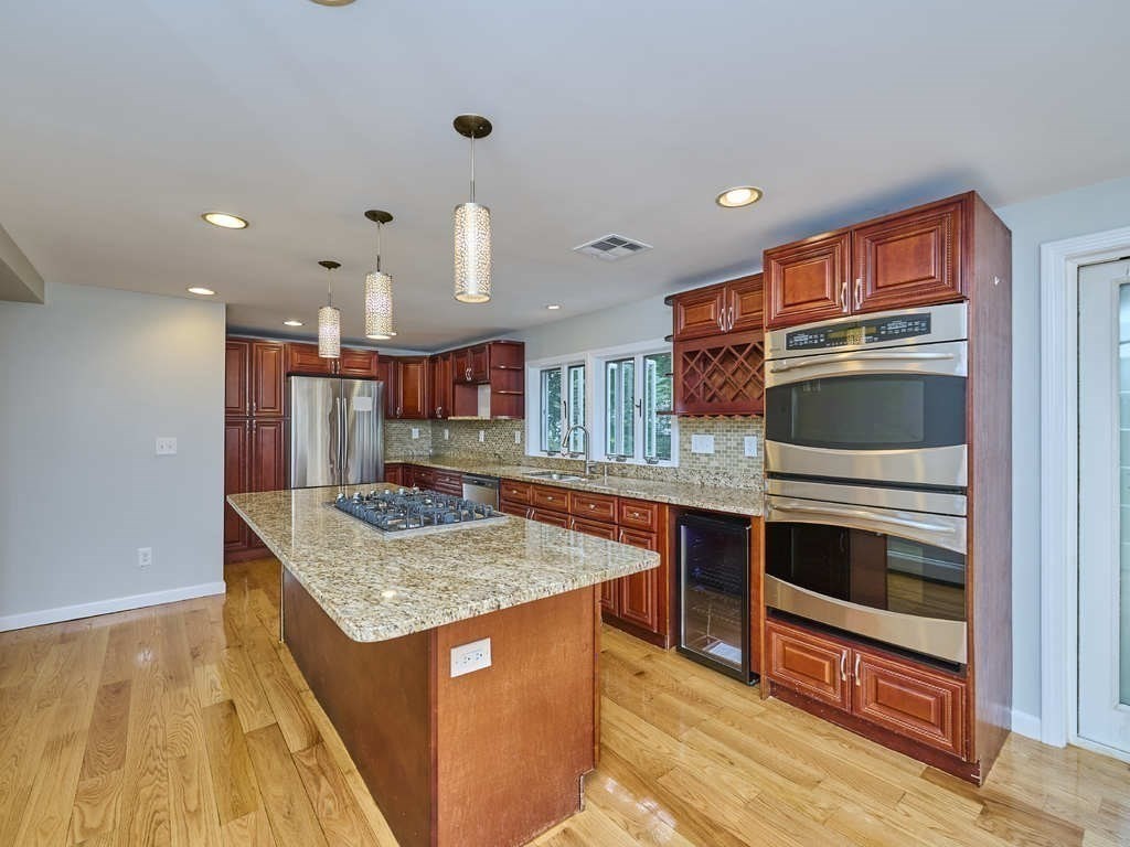 33 Theodore Road Newton, MA 02459 - Photo 14 of 42 a kitchen with stainless steel appliances granite countertop a stove and a sink