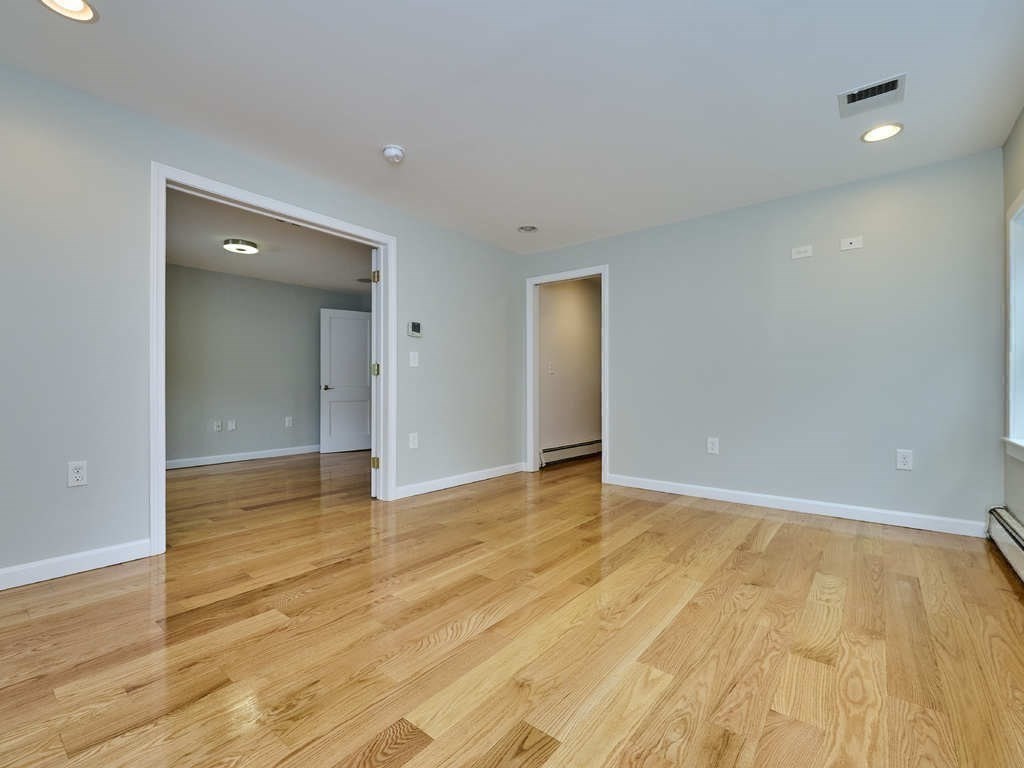 33 Theodore Road Newton, MA 02459 - Photo 20 of 42 a view of an empty room with wooden floor and closet