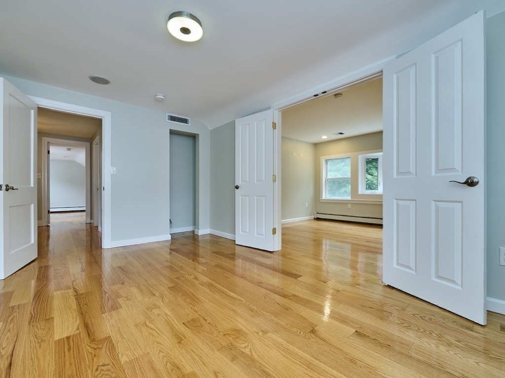 33 Theodore Road Newton, MA 02459 - Photo 22 of 42 a view of an empty room with wooden floor and a bathroom