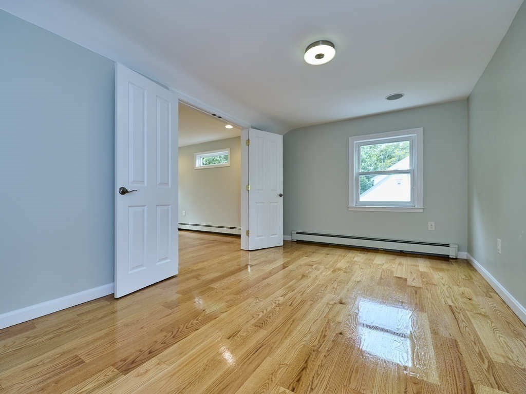 33 Theodore Road Newton, MA 02459 - Photo 23 of 42 an empty room with wooden floor and windows
