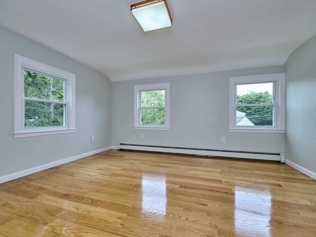 33 Theodore Road Newton, MA 02459 - Photo 24 of 42 a view of an empty room with wooden floor and a window