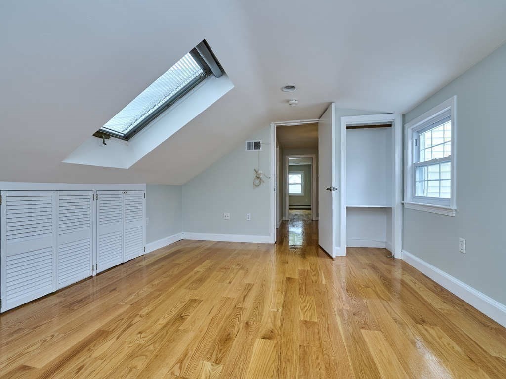 33 Theodore Road Newton, MA 02459 - Photo 29 of 42 a view of a big room with wooden floor and windows