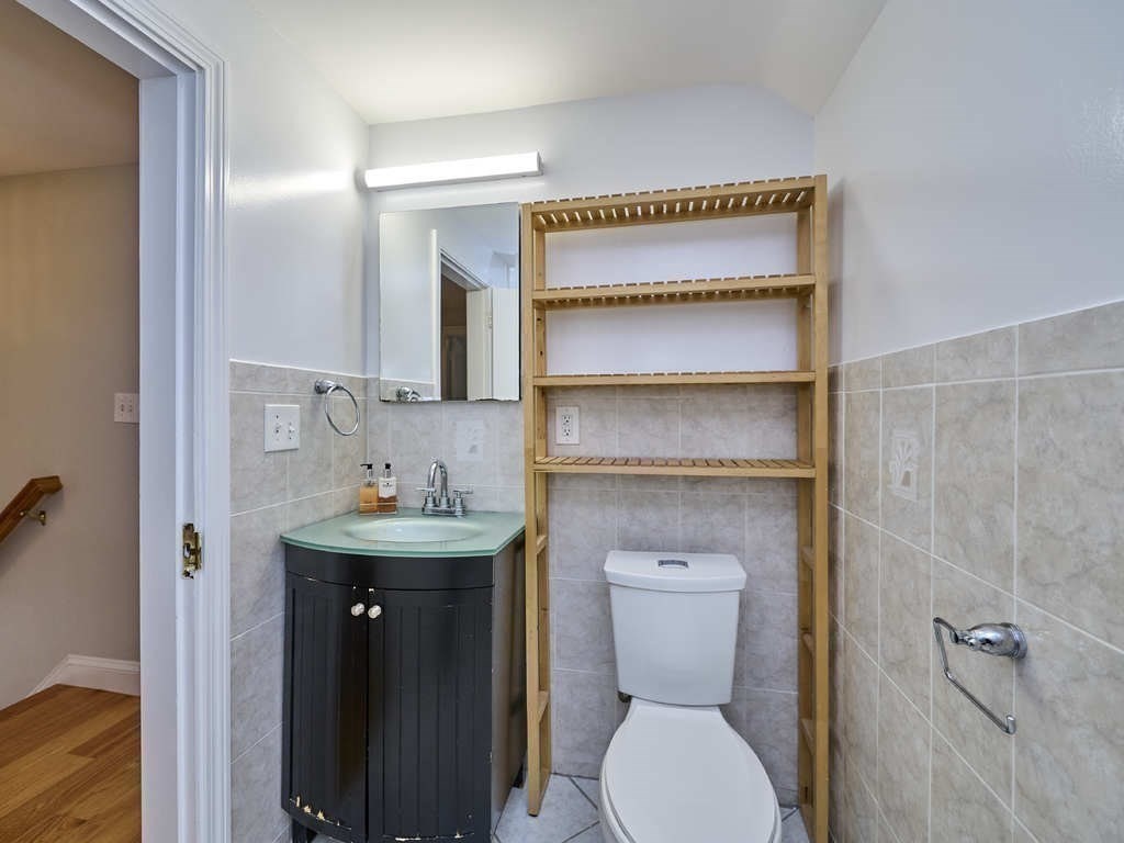 33 Theodore Road Newton, MA 02459 - Photo 30 of 42 a bathroom with a toilet sink and mirror