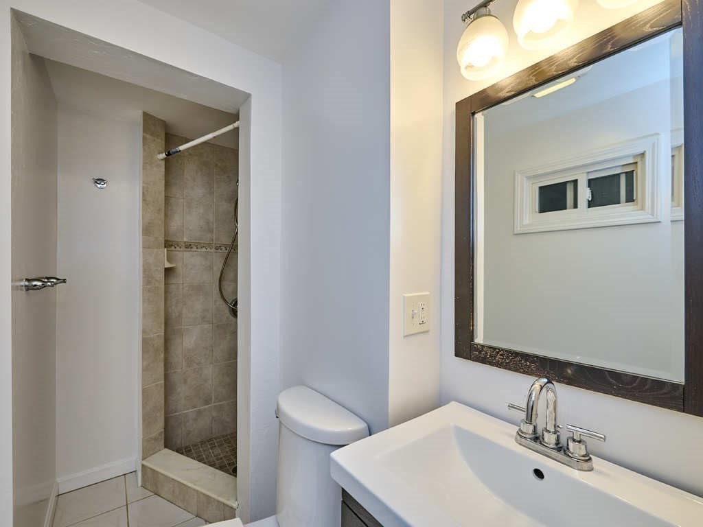 33 Theodore Road Newton, MA 02459 - Photo 32 of 42 a bathroom with a sink a toilet and shower